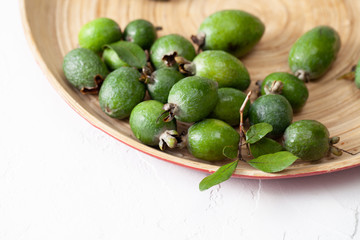 Fresh raw feijoa fruit in a plate on white