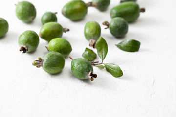 Fresh raw feijoa fruit on white concrete background