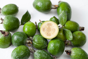 Fresh raw feijoa fruit on white concrete background