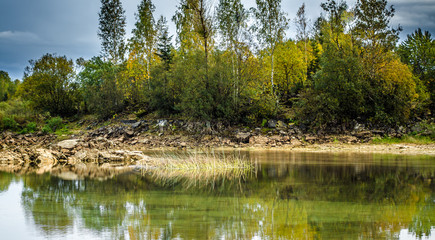 Sandy hills. Lake in the Sandy canyon. Warm colors background. Yellow sandstone textured mountain,...
