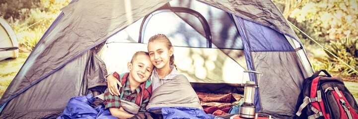 Siblings sitting in the tent