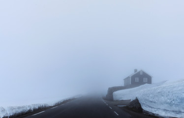 Frozen lonely house in the middle of nowhere in the winter. Heavy fog and a lot of snow. 