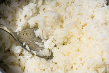 top view of spoon in a pan with boiled rice