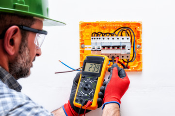 Electrician at work on an electrical panel.