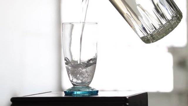 Serving water in a glass with white background