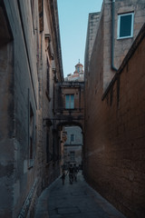 Fototapeta na wymiar Arched Balcony in a narrow street at Mdina Old Town,