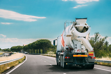 Concrete Transport Truck In-transit Mixer Unit In Motion On Coun - obrazy, fototapety, plakaty