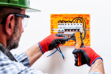 Electrician at work on an electrical panel.