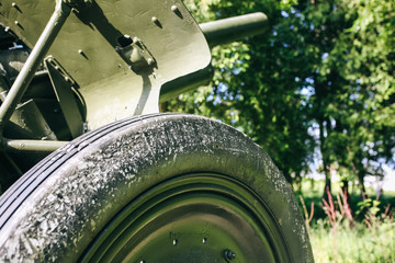 Old metal green cannon details from the time of Second World War. Weapon for fights from the past....