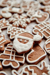 Composition of delicious gingerbread cookies shaped in various Christmas symbols. Placed on white rusty table. Top view.
