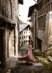 woman walking through old italian village - 231213227