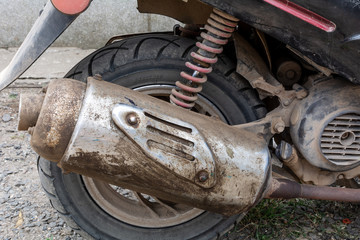 Dirty motorcycle exhaust pipe. Motorcycle elements close up. Moped scooter exhaust pipe, moped...