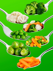 SPOONS WITH VEGETABLES ON GREEN