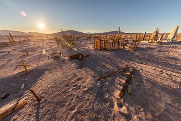 Amazing view over an old and abandoned saltpeter people cemetery inside the awesome Atacama Desert, loneliness to rest in peace in a remote location during the sunset hour. Taltal, Chile
