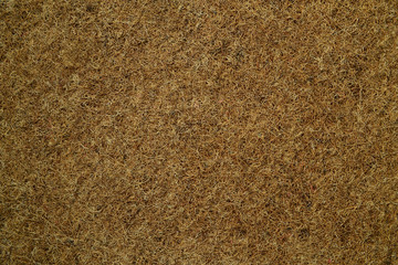 Mattress with organic coconut fiber. Grated coconut shell for the production of mattresses. Coir pressed at the factory. Background of fiber.