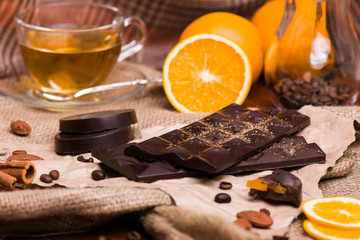 Black chocolate and orange. Chocolate with nuts on the table