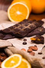Black chocolate and orange. Chocolate with nuts on the table