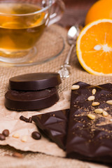Black chocolate and orange. Chocolate with nuts on the table