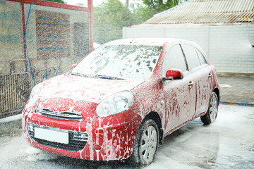 Cleaning vehicle with high pressure foam jet at car wash