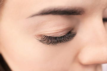 Beautiful young woman with eyelash extensions, closeup