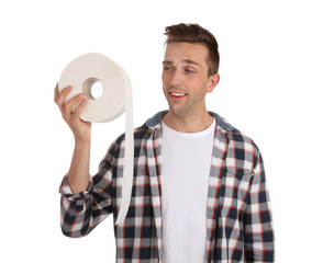 Young man holding toilet paper roll on white background