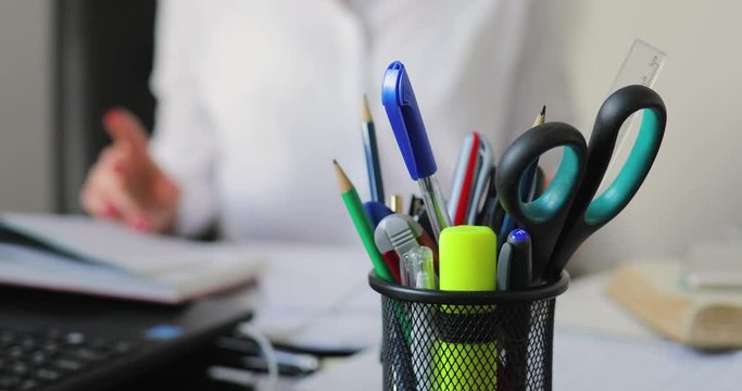 Businesswoman working on background, she take a pen and writing document