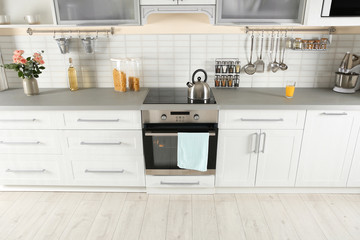 Light modern kitchen interior with new oven