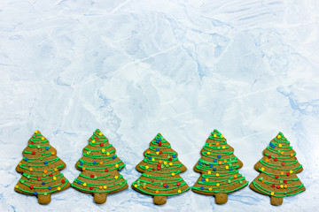 Christmas tree cookies - homemade gingerbread cookies with green icing and colorful sugar sprinkles...