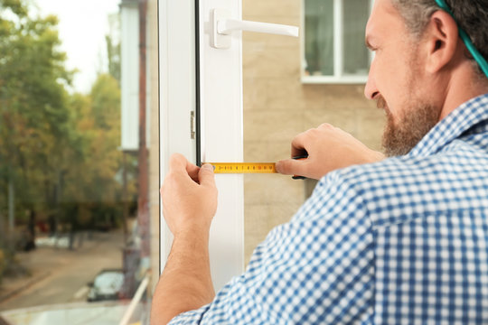 Man installing new modern window in house