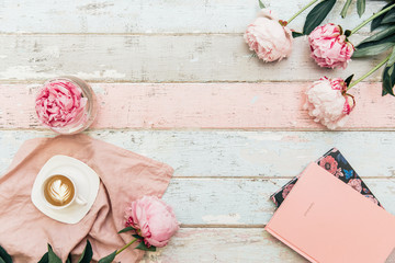 Flat lay trendy background . Coffee with notebook, and peony flower