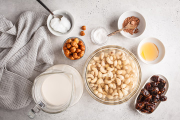 Ingredients for raw vegan cake, cashew cake on a white background.