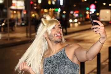 Transvestite taking a selfie outdoors