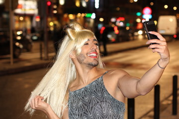 Transvestite taking a selfie outdoors 