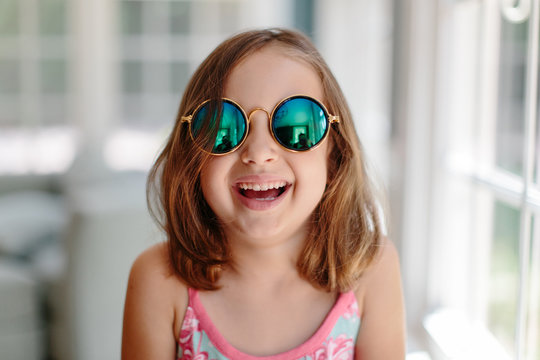Cute young girl with sunglasses laughing
