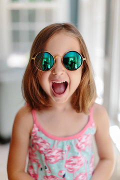 Cute young girl with sunglasses making a surprised face