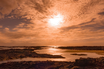 Beautiful colourful low sun over the sea at El Cottillo,Fuerteventura,Canary-Islands,Spain.