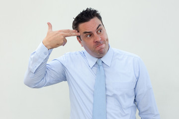 Frustrated middle-aged businessman making finger gun gesture and looking away. Upset frowning man in formal shirt having problem. Failure concept