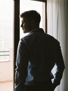 Elegant muscular man near window