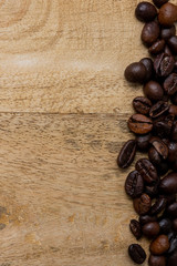 coffee beans on wooden background with copy space for your text in vertical position