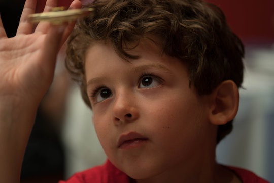 portrait of a boy looking at widget spinner