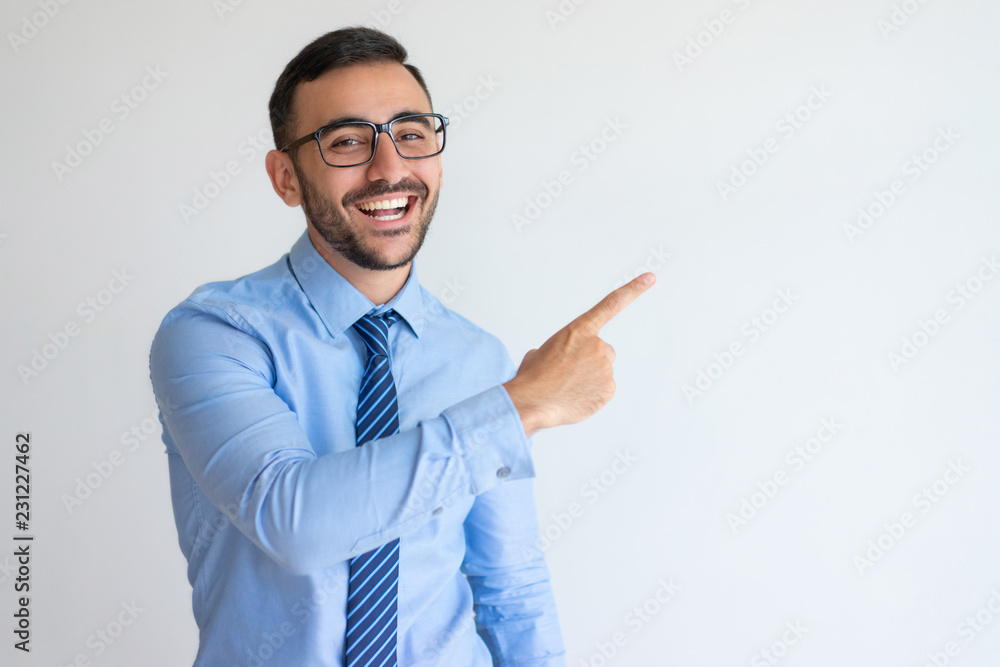 Wall mural excited entrepreneur in glasses pointing aside and laughing. cheerful successful business trainer ho