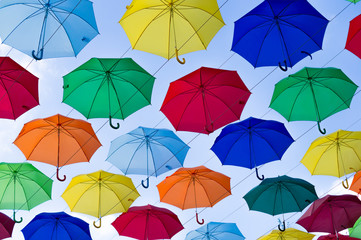 Fototapeta na wymiar many bright umbrellas against the sky
