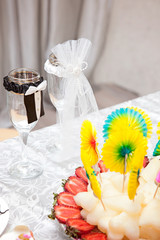 cheerful wedding celebration with a beautiful festive table, treats, champagne glasses, candles, flowers in the restaurant with a magnificent decor