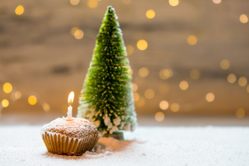Fototapeta na wymiar cupcake with candle on winter background