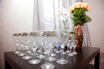 cheerful wedding celebration with a beautiful festive table, treats, champagne glasses, candles, flowers in the restaurant with a magnificent decor