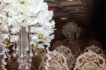 cheerful wedding celebration with a beautiful festive table, treats, champagne glasses, candles, flowers in the restaurant with a magnificent decor