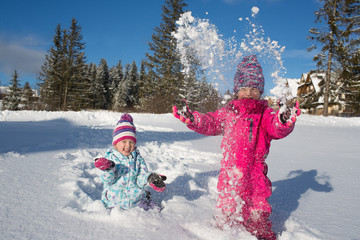 happy girls playing in the snow