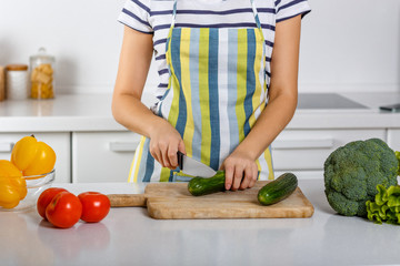 Woman cooking in the kitchen fresh vegetable salad