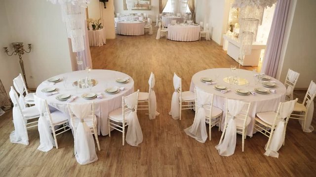 a served table with a white cloth on which there are plates and napkins