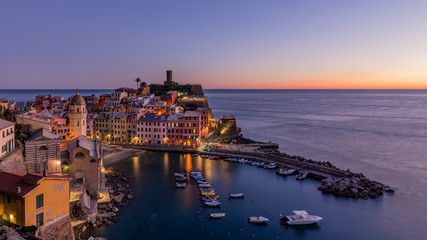 Fototapeta na wymiar Colorful aerial view of the historic center of Vernazza after sunset, Cinque Terre park, Liguria, Italy